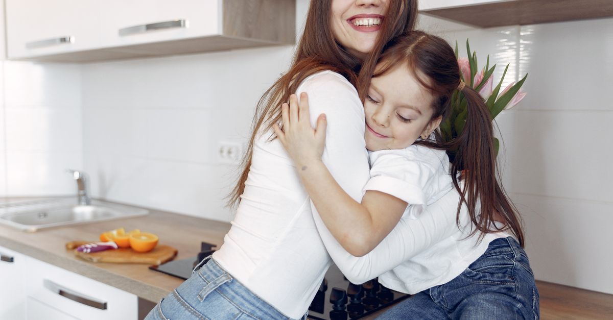 A parent and child sharing a warm hug at home.